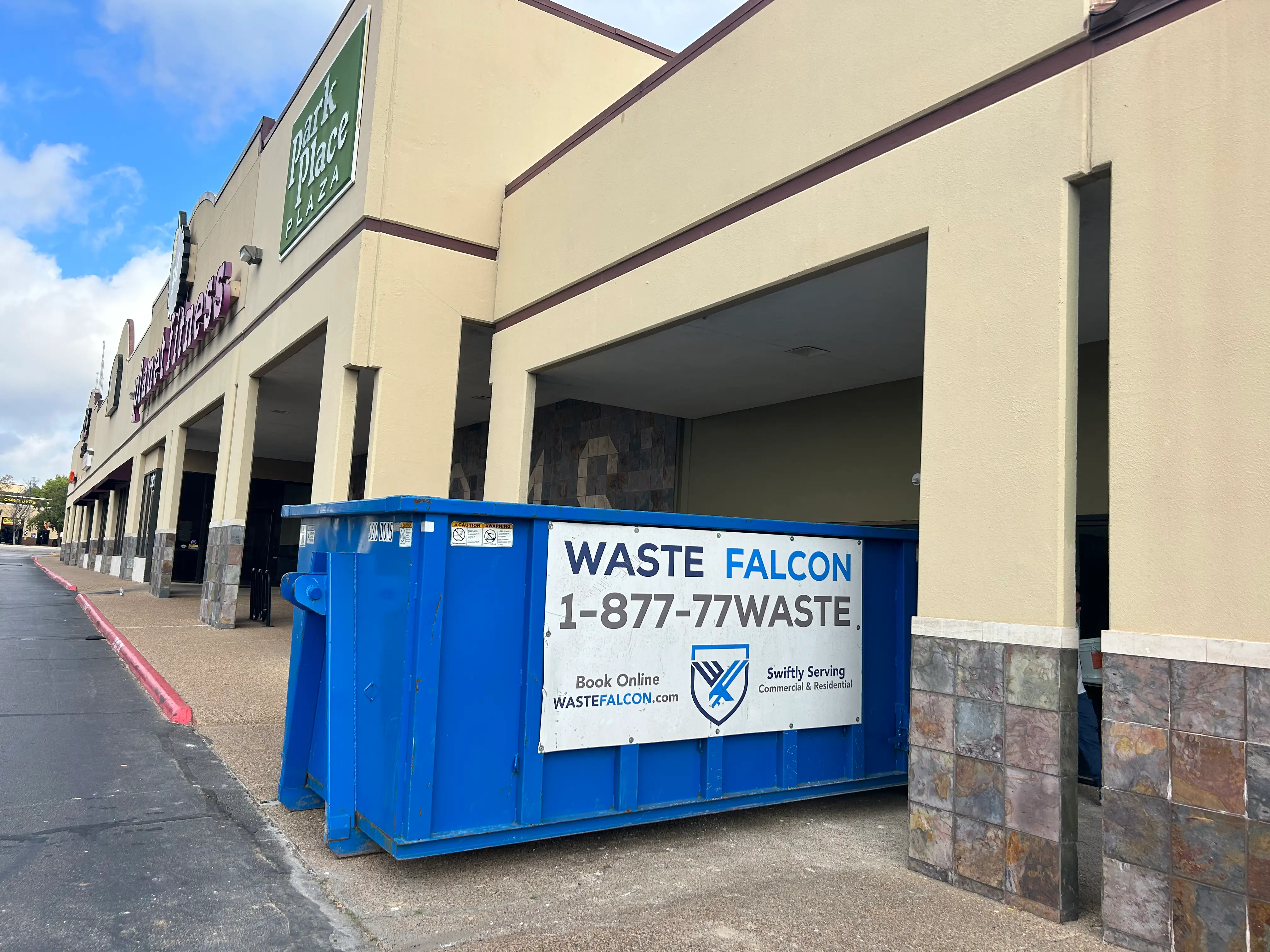Waste Falcon Commercial Dumpster Rental near warehouse