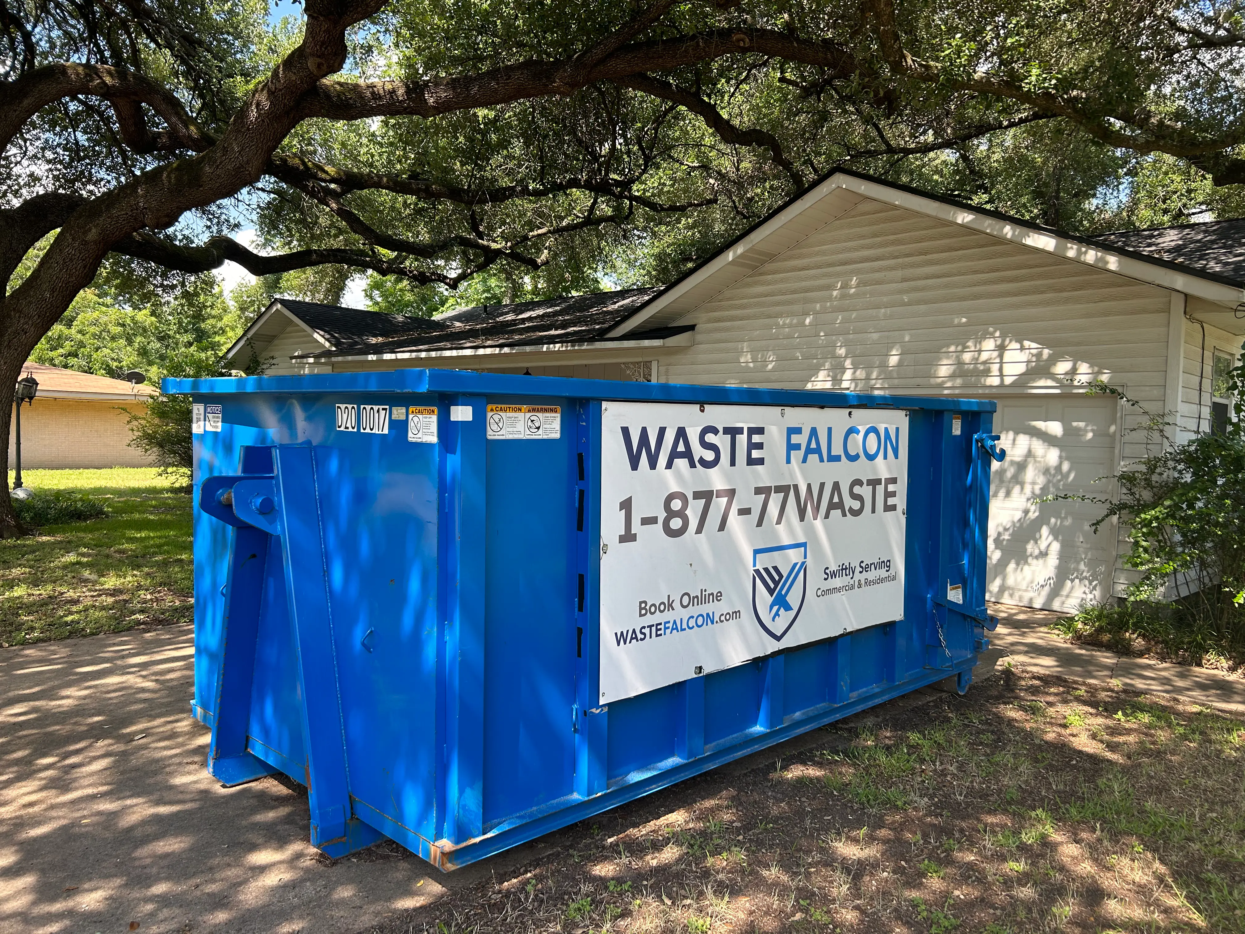 Waste Falcon Residential dumpster rental outside a home